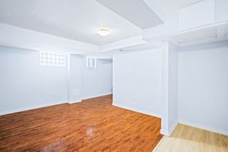 an empty room with blue walls and a wood floor