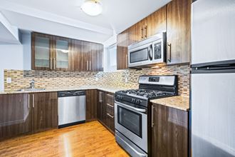 a kitchen with stainless steel appliances and wooden cabinets