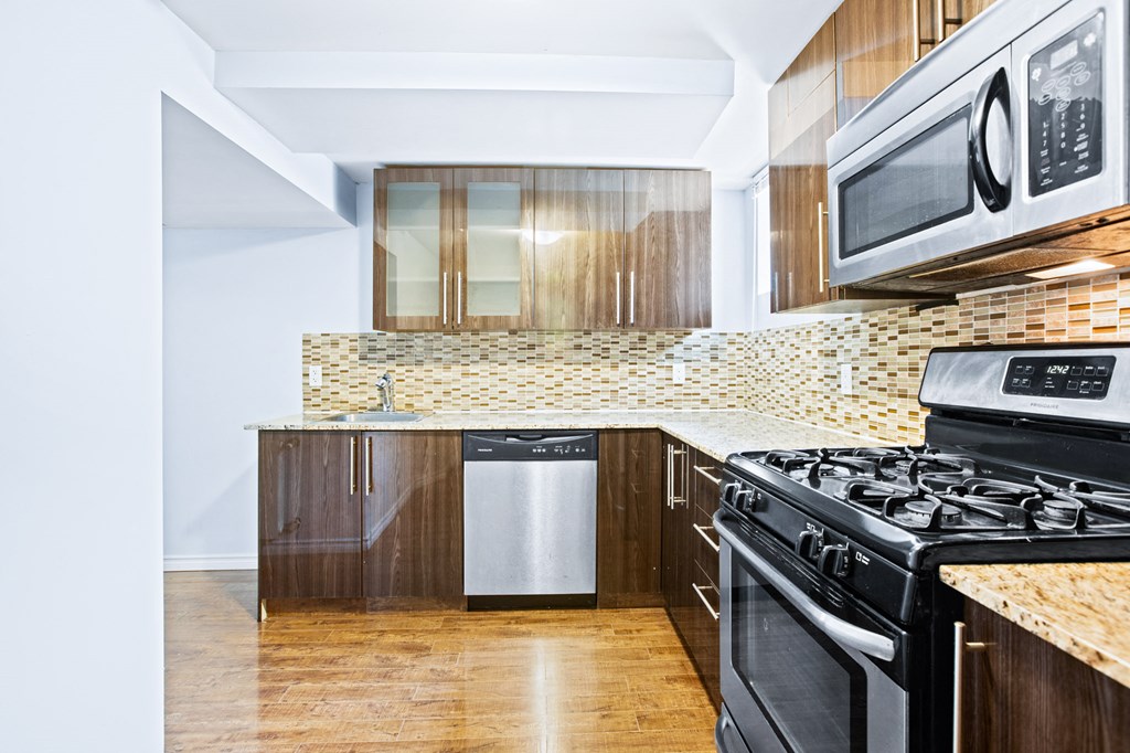 a kitchen with black appliances and wooden cabinets