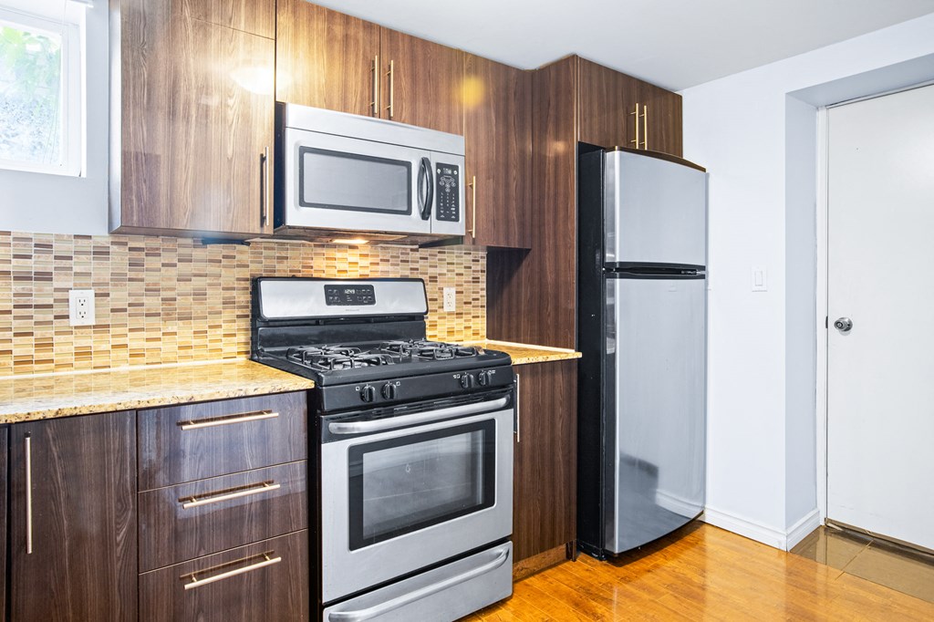 a kitchen with stainless steel appliances and a refrigerator