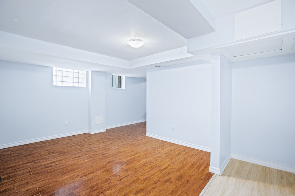 an empty living room with wood floors and blue walls