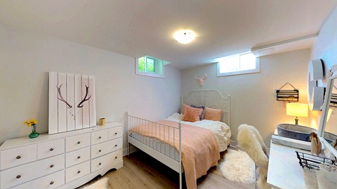 a bedroom with a bed and a dresser