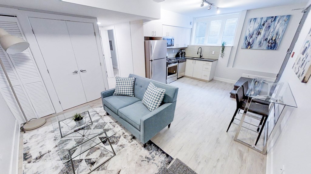 a living room with a couch and a kitchen