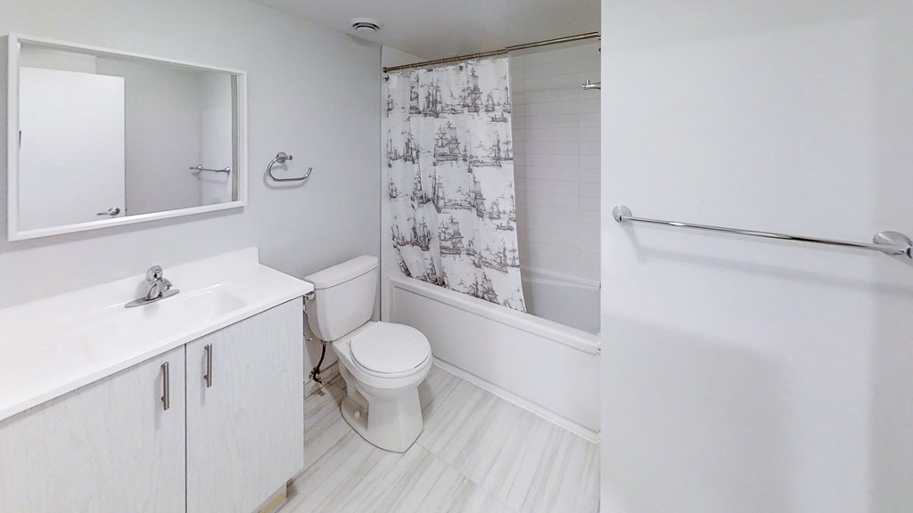 a bathroom with a shower and a sink and a toilet