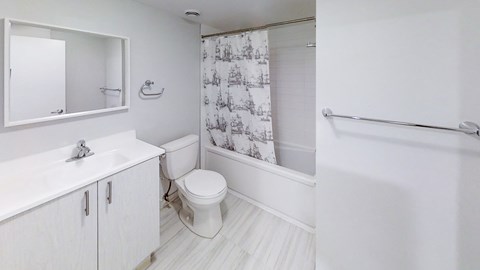 a bathroom with a shower and a sink and a toilet