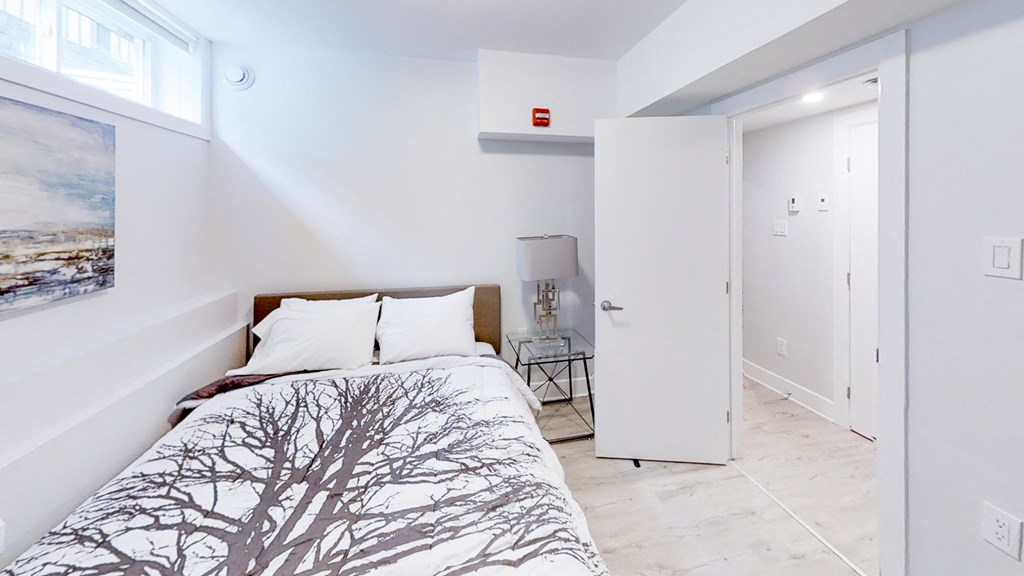 a bedroom with a bed and a door to a bathroom