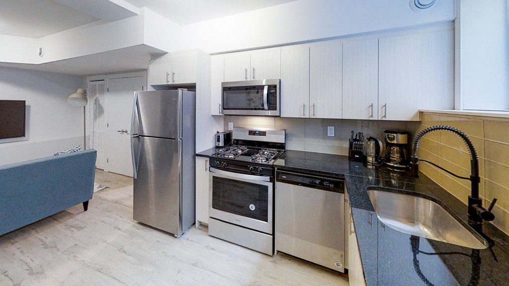 a kitchen with stainless steel appliances and white cabinets
