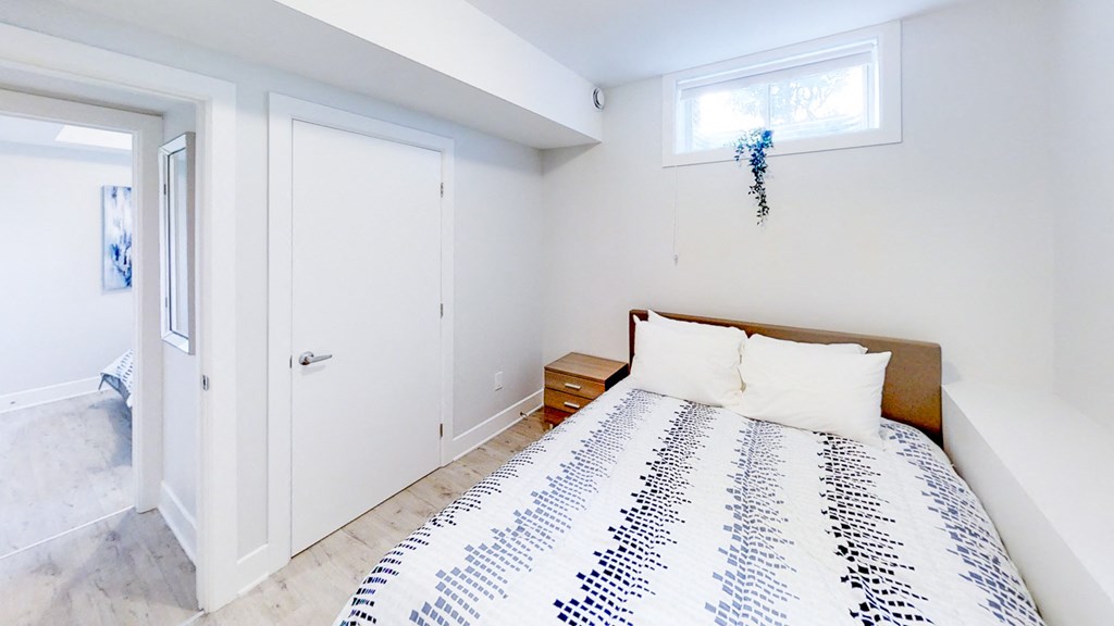 a bedroom with a bed and a door to a bathroom