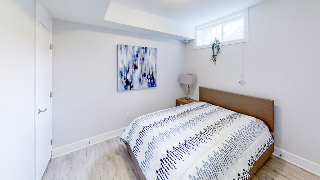 a bedroom with a bed and a window