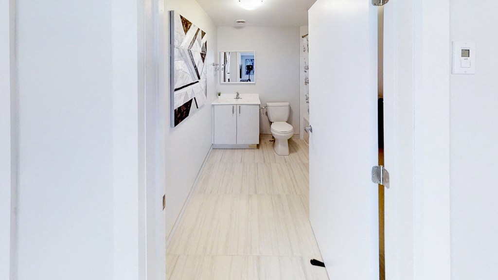 a white bathroom with a toilet and a sink