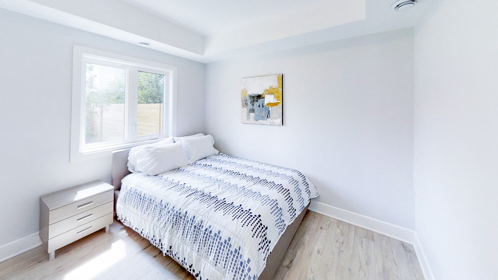 a small bedroom with a bed and a window