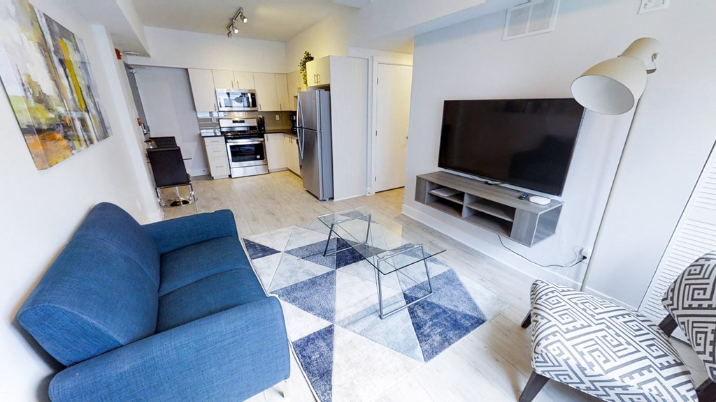 a living room with a blue couch and a tv