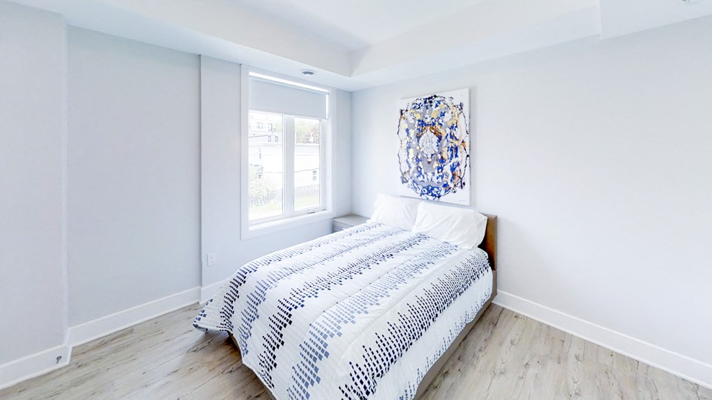 a bedroom with a bed and a window