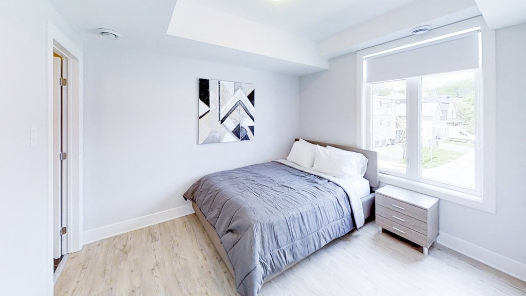 a bedroom with a bed and a large window