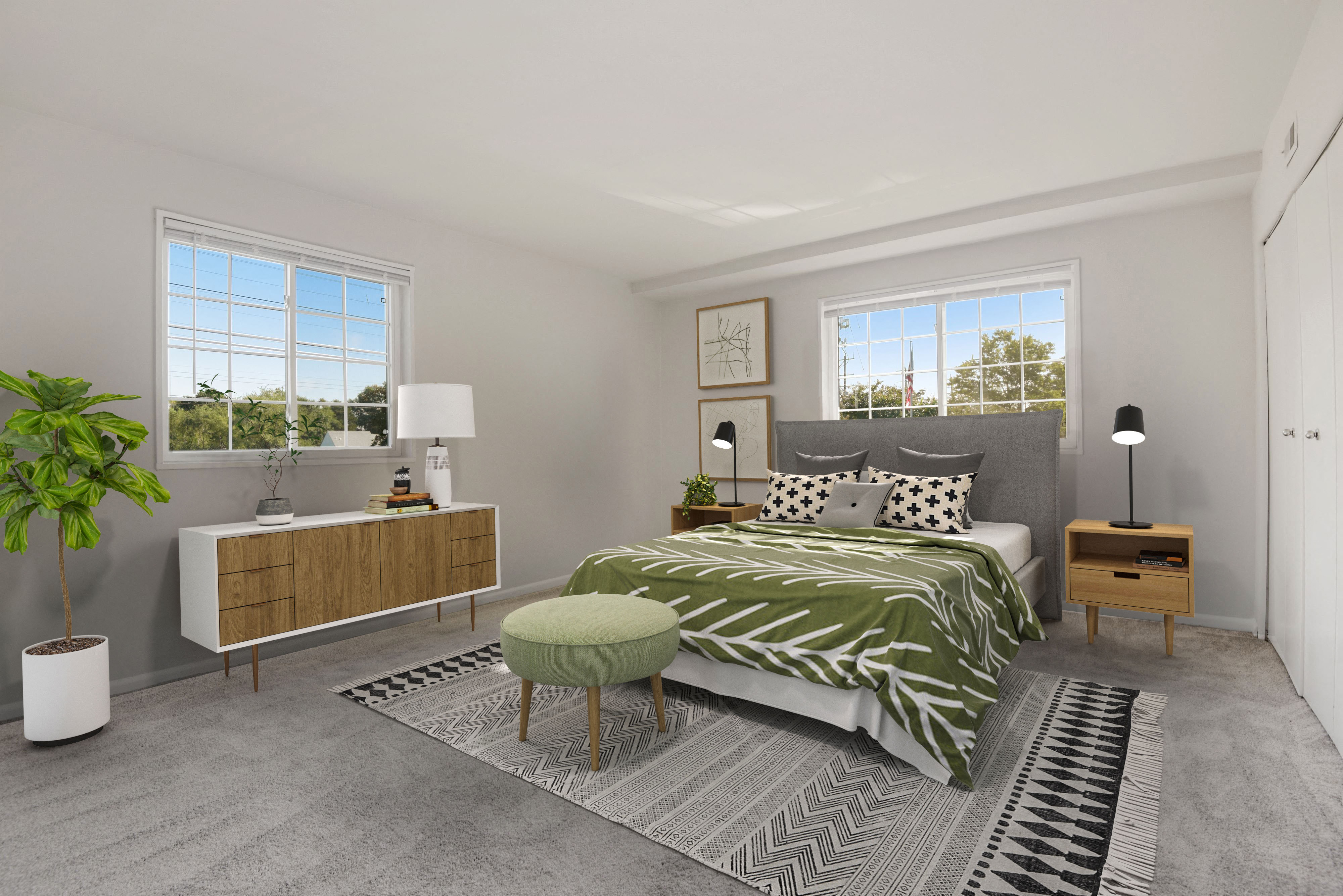 Large furnished bedroom with two big windows and lots of natural light