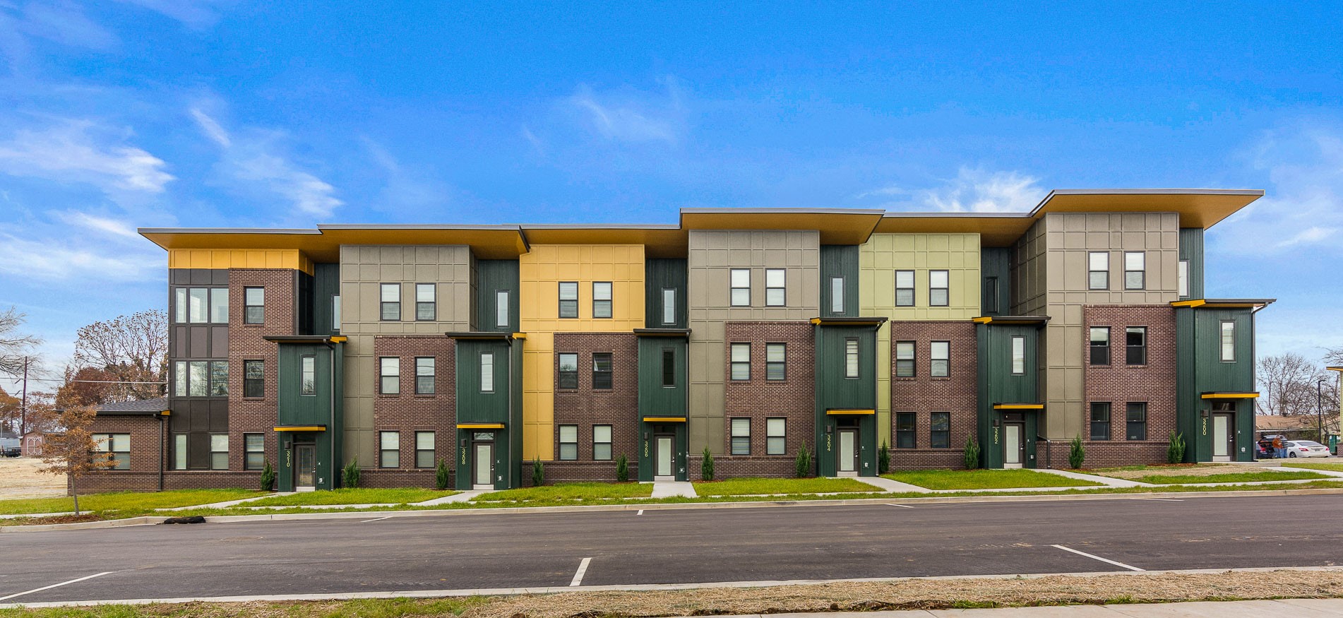 an apartment building with a street in front of it