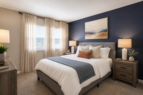 A bedroom with a large bed, a nightstand, and a painting on the wall.