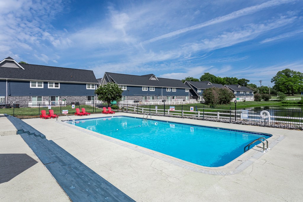 a swimming pool with a house in the background