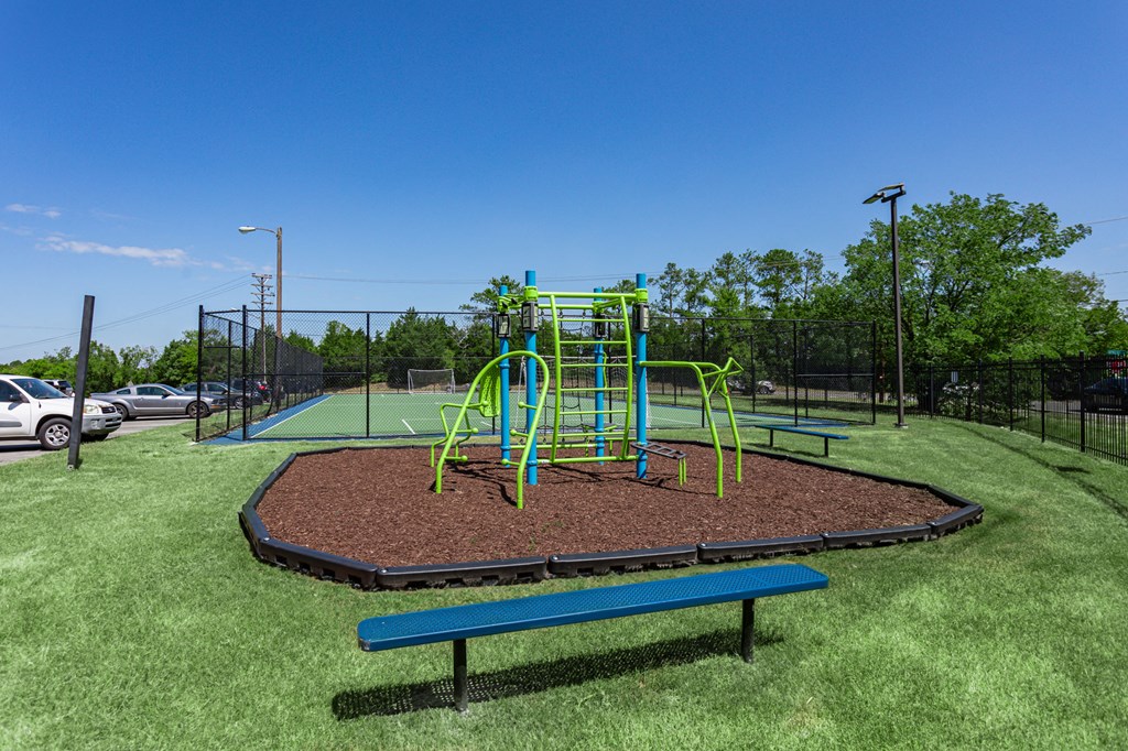 a playground with a jungle gym and a swing set