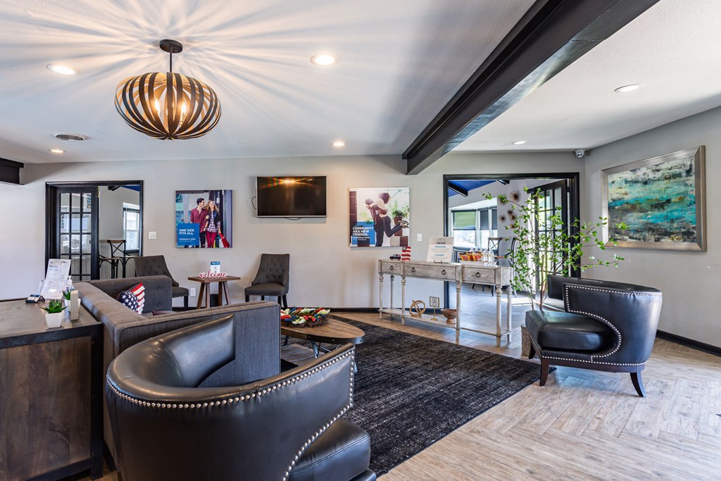 a living room with leather furniture and a tv