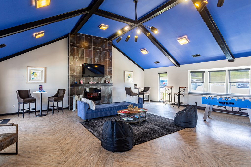 the preserve at ballantyne commons community room with blue ceilings and a fireplace
