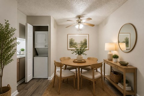 A small dining room with a round table and chairs.