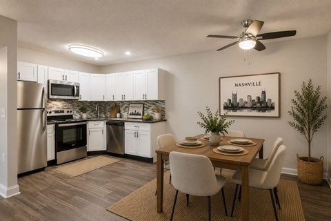 A kitchen with a dining table and chairs.