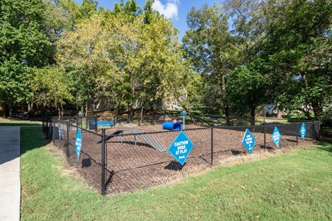 A fenced area with blue signs that say "Caution Please Keep Out".