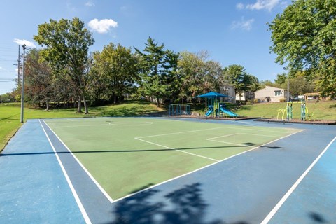 A tennis court with a blue surface and white lines.