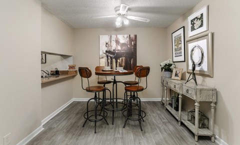 A room with a bar and chairs.
