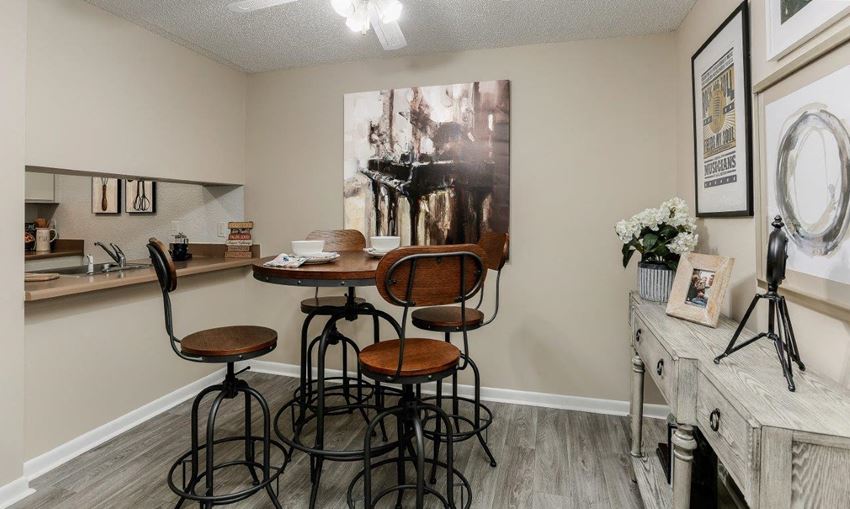 a bar area with stools and a counter with a sink