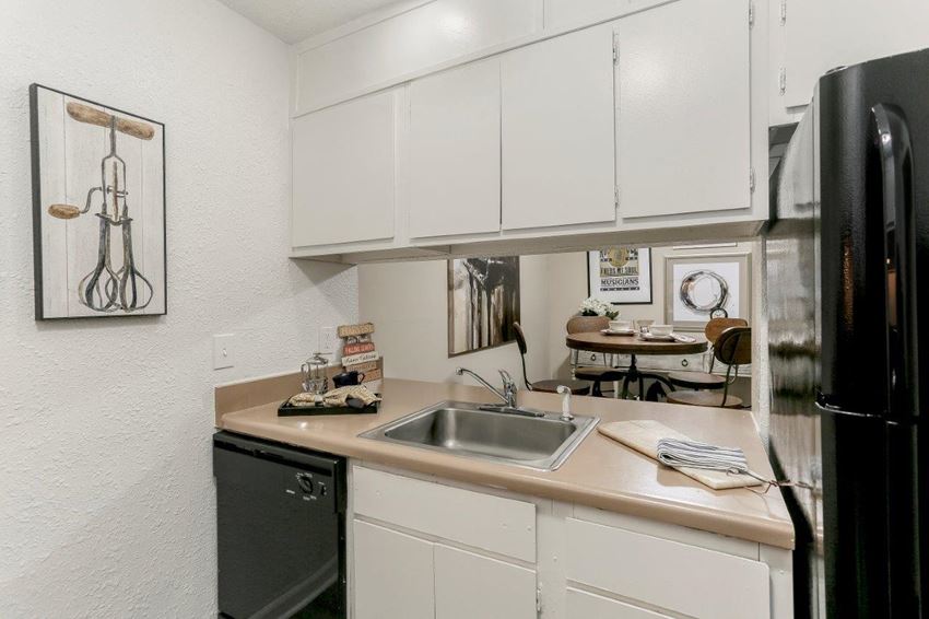 a kitchen with a sink and a refrigerator