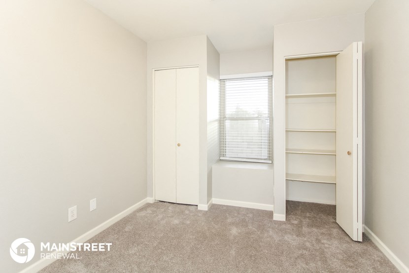 a bedroom with a closet and a window