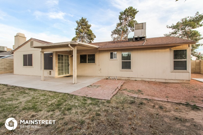 a white house with a patio and a yard