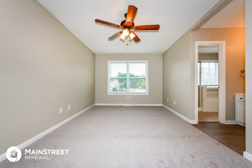 the master bedroom is spacious and has a ceiling fan