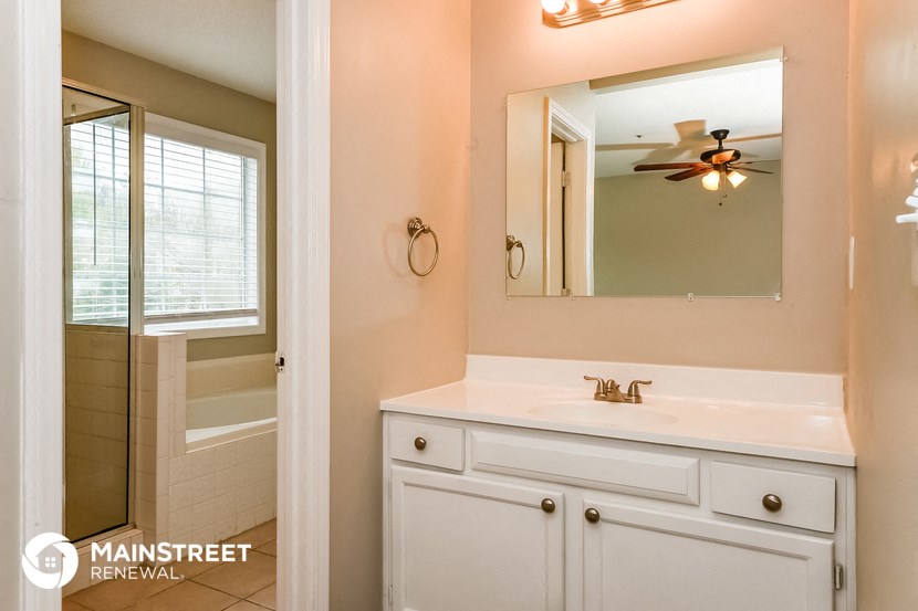 a bathroom with a sink and a mirror and a shower