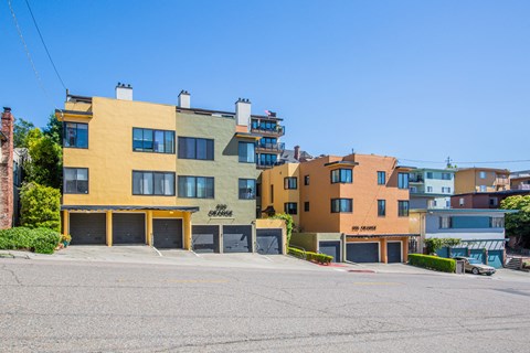 A row of colorful buildings with the number 900 on the yellow one.