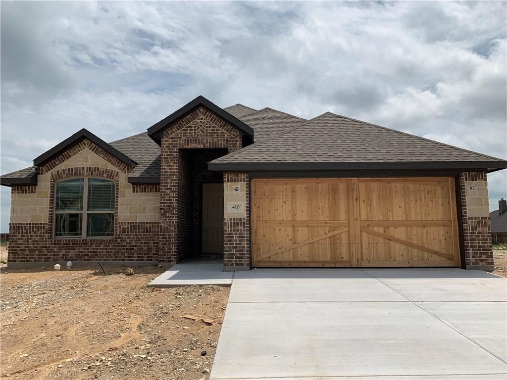 a house with a driveway and a garage door