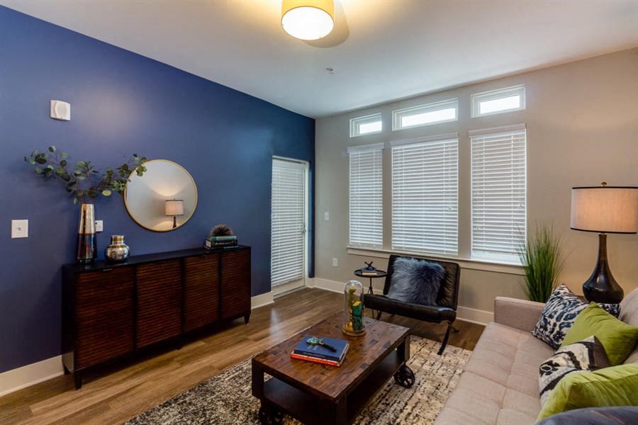 a living room with a blue wall and a couch and a table