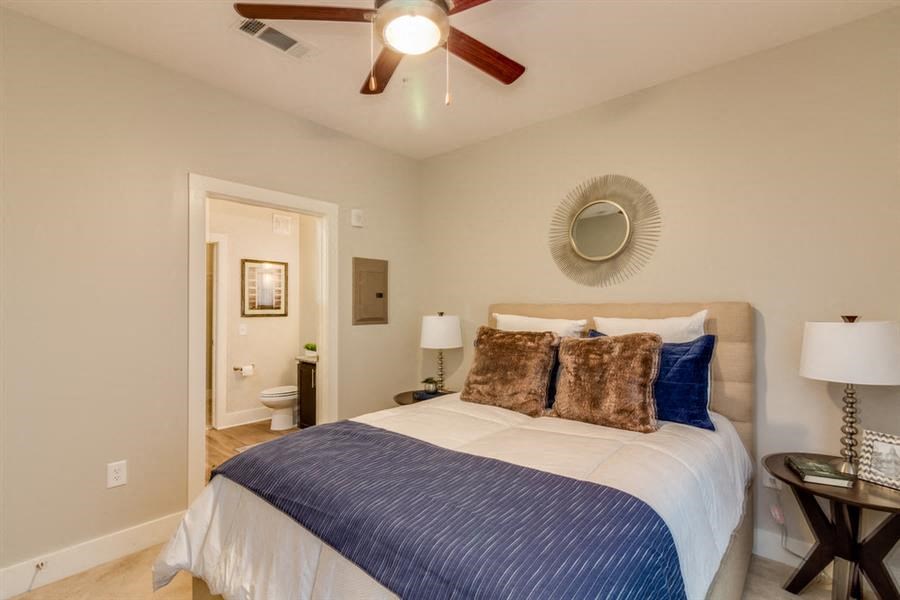 a bedroom with a bed and a ceiling fan