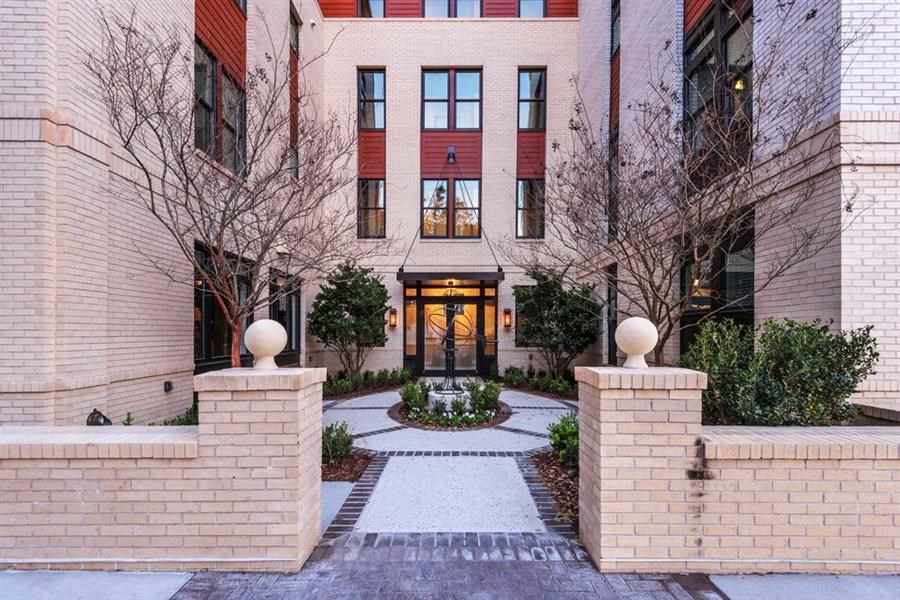 a courtyard with a fountain in the middle of a brick building