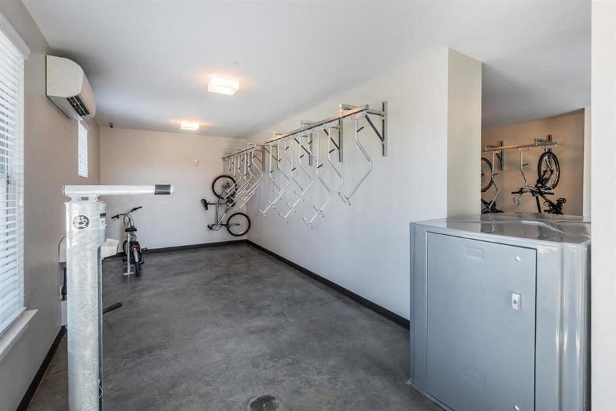 a room with a refrigerator and bikes on the wall