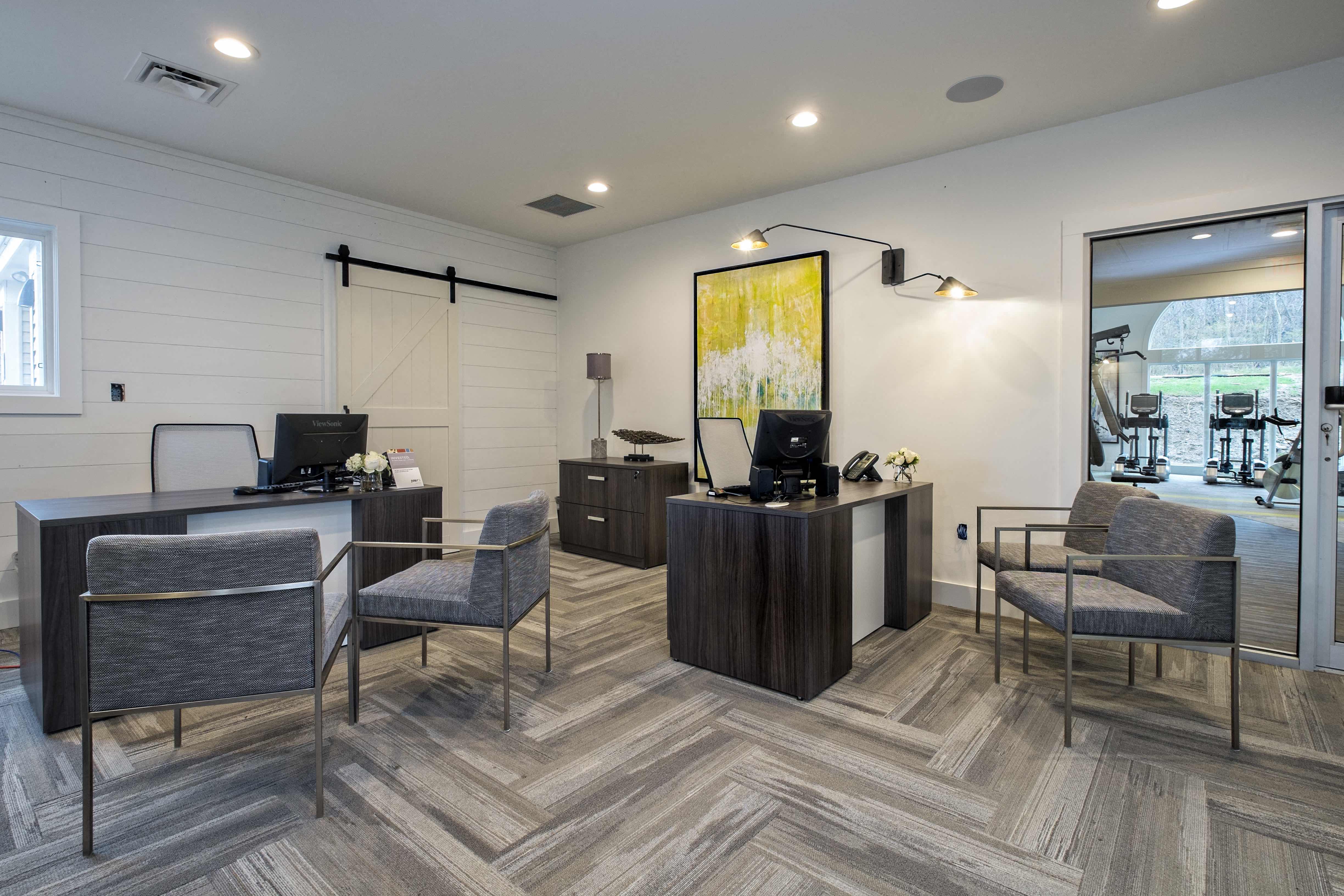 a modern office with chairs and desks and a window