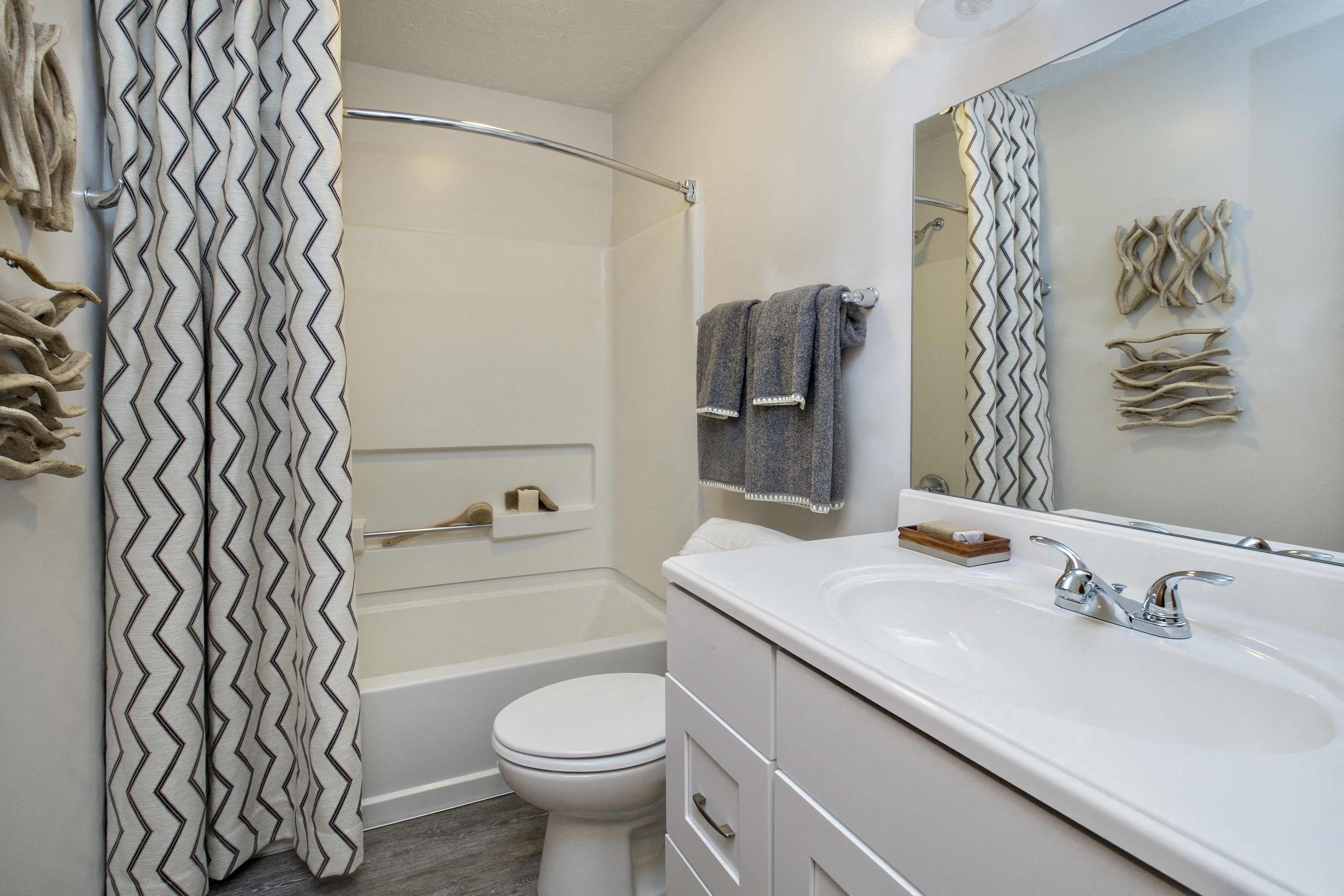 a bathroom with a sink and a toilet and a shower