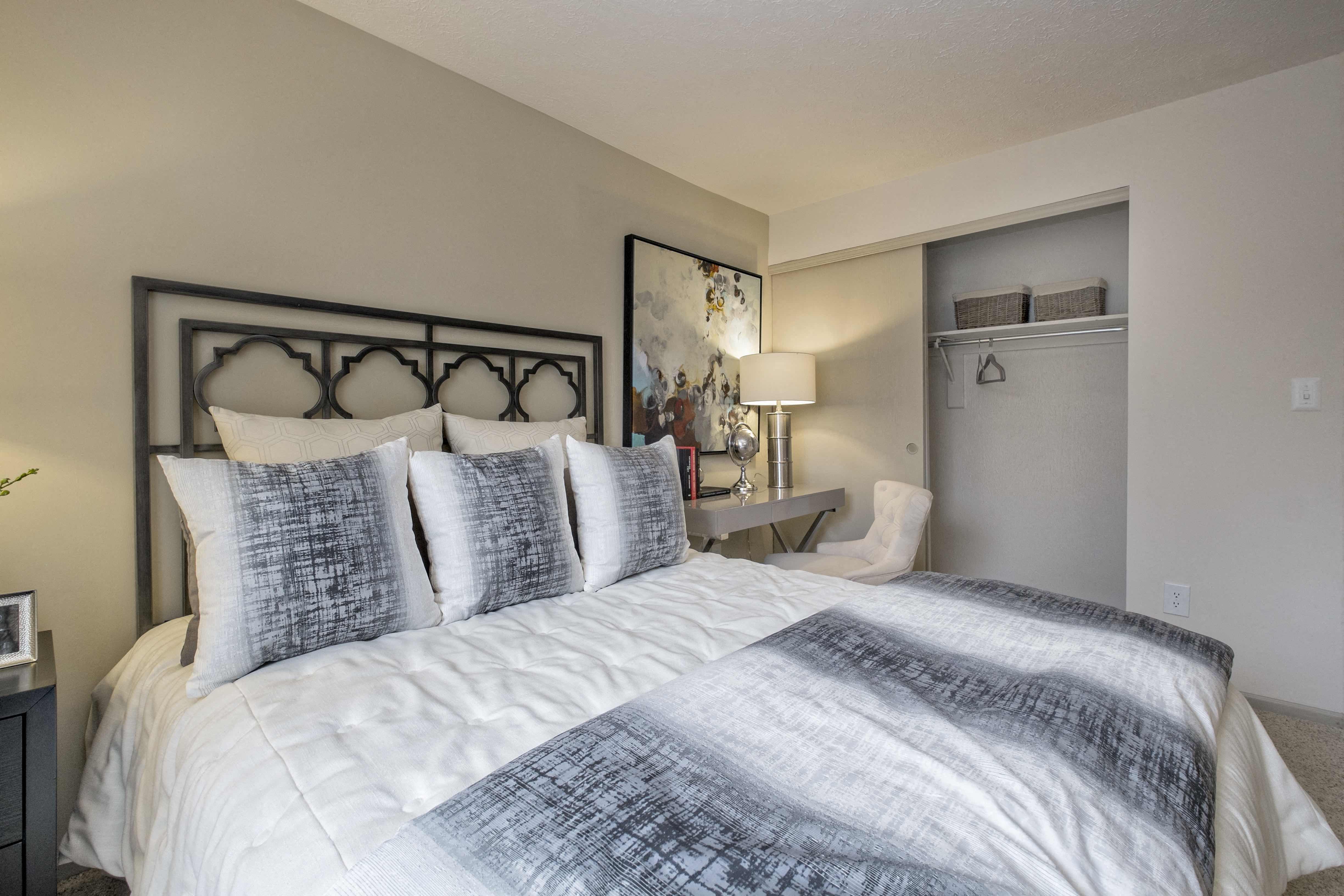 a bedroom with a large bed and a closet