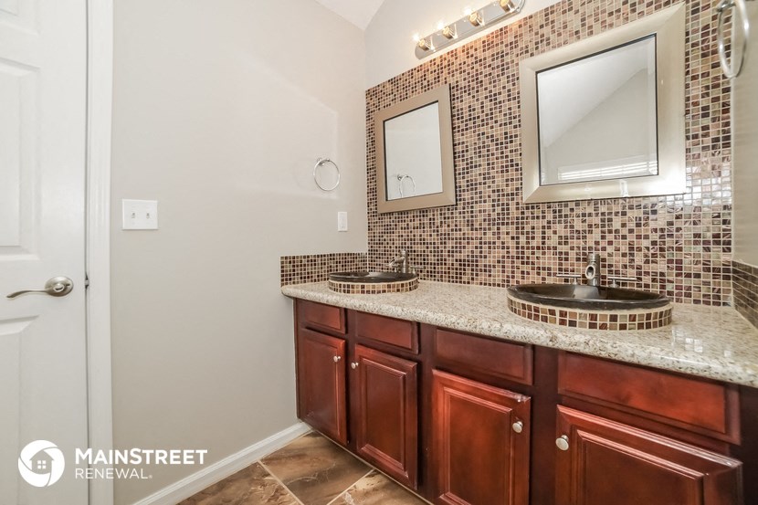 a bathroom with two sinks and a large mirror