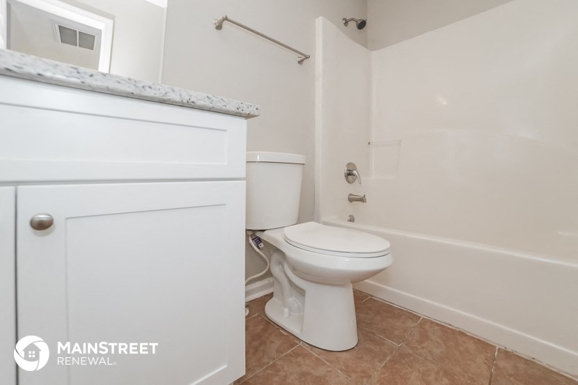 a bathroom with a toilet and a tub and a sink