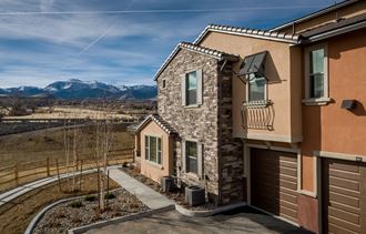 new home with mountains in the background and sidewalk in front