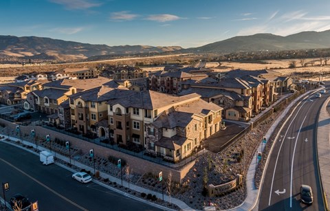 an aerial view of a neighborhood with cars on the street and buildings