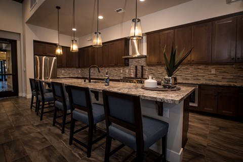 a kitchen with a large island with bar stools